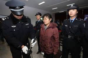 Zhang Shuxia escorted by policemen