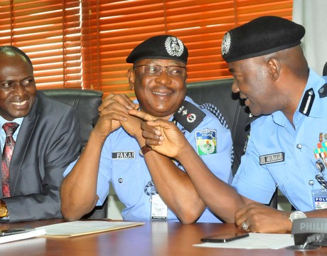 IGP MOHAMMED ABUBAKAR (R), DISCUSSING WITH THE DIG ADMINISTRATION, MR SULEIMAN FAKAI AND DIG CID, MR PETER GANA, DURING THE DECORATION OF THE SENIOR POLICE OFFICERS IN ABUJA ON WEDNESDAY (22/1/14).