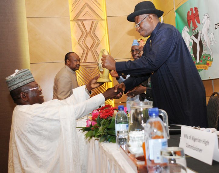PRESIDENT GOODLUCK JONATHAN RECEIVING A SOUVENIR FROM THE PRESIDENT, NIGERIAN COMMUNITY IN NAMIBIA, MR BUBA MADUGU, AT A MEETING OF PRESIDENTJONATHAN WITH NIGERIANS IN NAMIBIA ON THURSDAY (NAN)