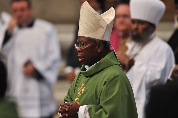 Nigerian Cardinal Francis Arinze (C) att