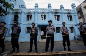 Policemen at a mosque housing orphans where a fire broke out in Yangon, Myanmar. 