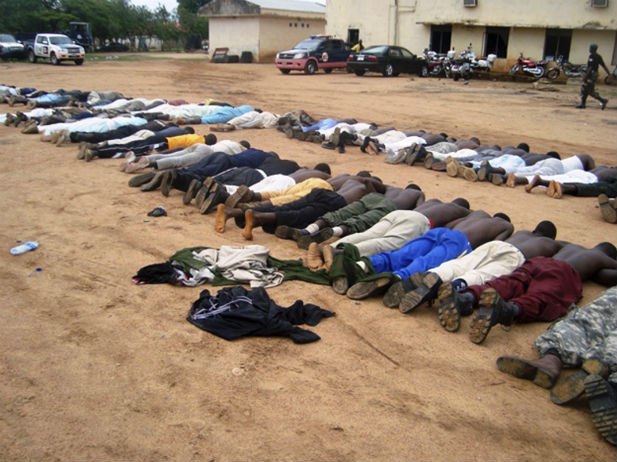 SUSPECTED TERRORISTS MADE TO LIE FACE DOWN AT A POLICE STATION IN NORTHERN NIGERIA