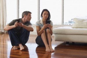 Couple with Cellular Phones in Condominium