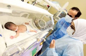 Ranim Amir and Hassan check on one of their babies at the Saudi-German Hospital in Dubai. Image Credit: Gulf News