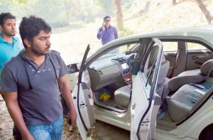 Qamar Abbas, the son of slain government prosecutor Chaudhry Zulfiqar looks at the bullet-riddled car of his father after an attack by gunmen in Islamabad on Friday.