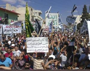 Demonstrators protest against Syria's President Bashar al-Assad after Friday prayers in Houla