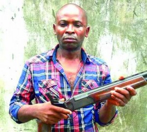 the suspect, Obinna-Onyekulujie with of the weapons found in his possession