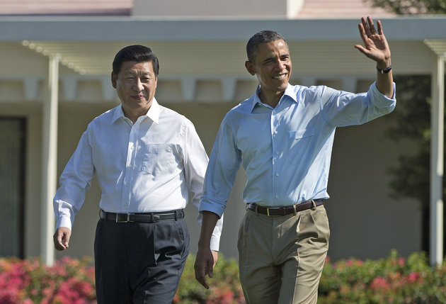 President Barack Obama, right, walks with Chinese President Xi Jinping at the Annenberg Retreat of the Sunnylands estate Saturday, June 8, 2013, in Rancho Mirage, Calif
