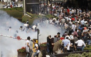 Turkish riot police use tear gas to disperse demonstrators during protest against destruction of trees in park brought about by pedestrian project, in Taksim Square in central Istanbul