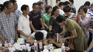 The parents of Flight 214 victim, Wang Linjia, are comforted by parents of some other students who were on the Asiana Airlines jet that crashed at San Francisco International Airport. 