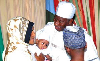 PRESIDENT GOODLUCK JONATHAN WITH WOMAN AND HER KIDS FROM THE FCT MUSLIMS COMMUNITIES DURING A VISIT TO THE PRESIDENT AT THE STATE HOUSE ABUJA ON THURSDAY 8TH AUGUST 2013 