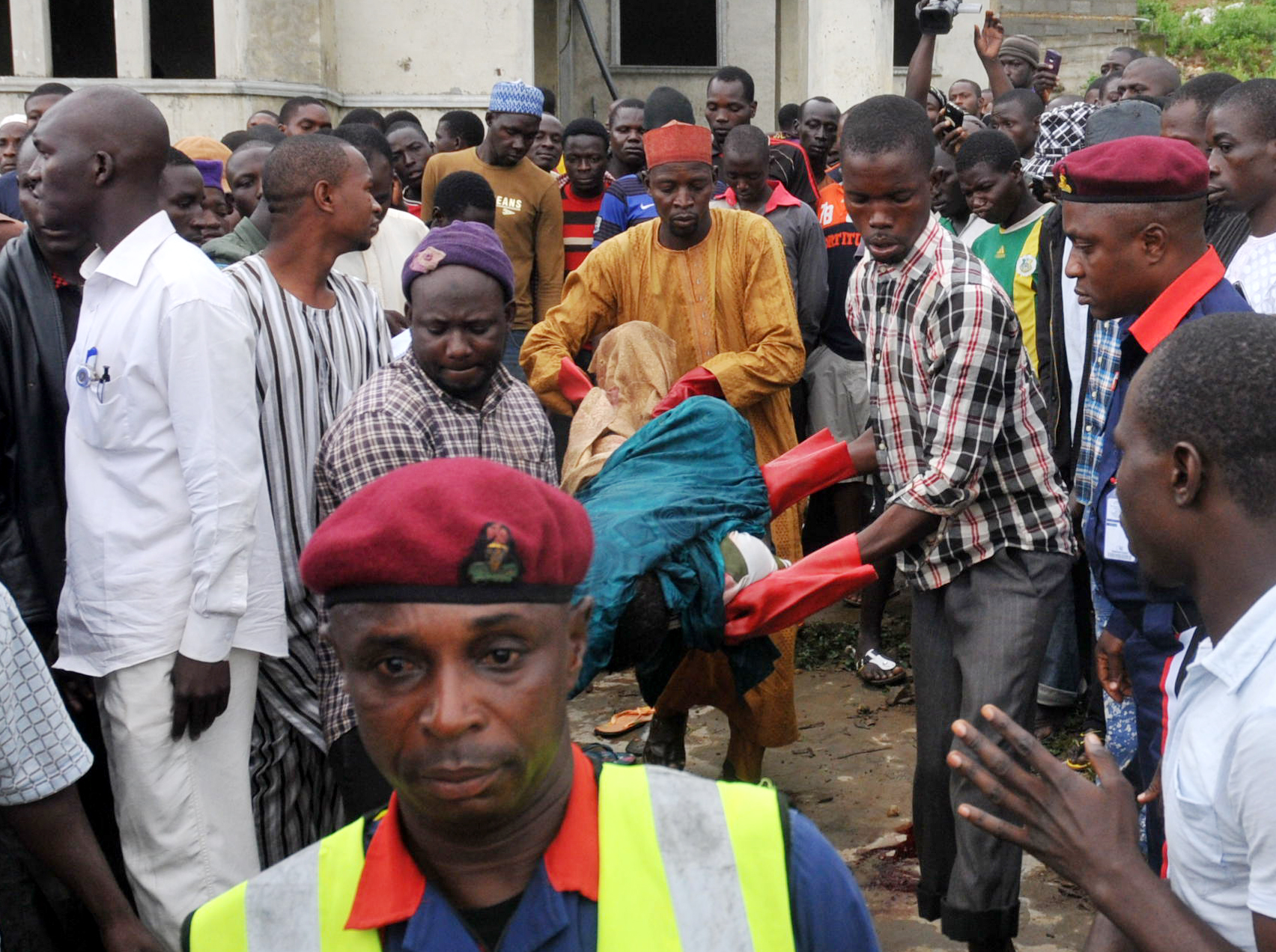 RESCUE WORKERS EVACUATING REMAINS OF PEOPLE KILLED IN AN UNCOMPLETED BUILDING BY UNKNOWN GUNMEN AT APO ZONE E IN ABUJA 