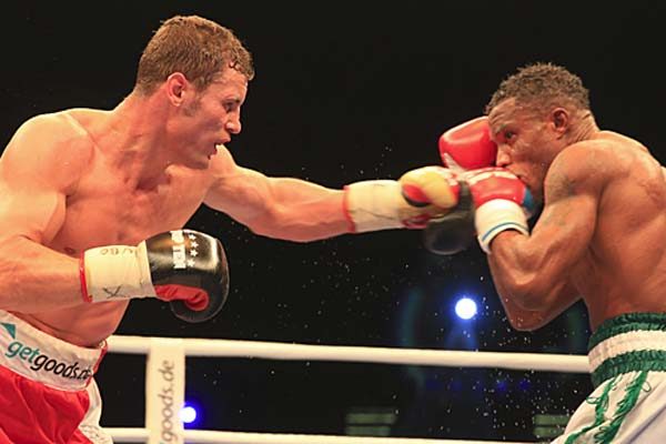 Image: Peter Gercke for SES Boxing. Robert Stieglitz Left-Handed Punch Brushes Ekpo's Jaw.
