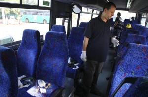 An Israeli policeman surveys the scene of a stabbing incident on a bus in the northern Israeli town of Afula