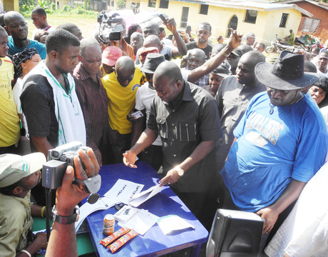 ANAMBRA PDP GOVERNORSHIP CANDIDATE, MR TONY NWOYE, EXPRESSING WORRY OVER THE DISAPPEARANCE OF HIS NAME, THAT OF HIS FATHER AND UNCLE FROM INEC VOTERS REGISTER AT POLLING UNIT 004, OFIANTA, NSUGBE WARD ONE, ON SATURDAY (16/11/13) DURING  GOVERNORSHIP ELECTION.