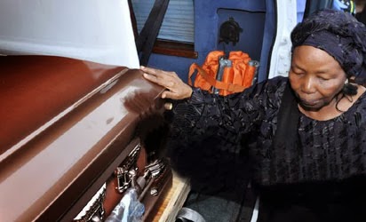 SOLOMON LAR'S WIDOW TOUCHING THE COFFIN CONTAINING HIS REMAINS