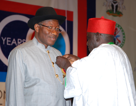 NATIONAL CHAIRMAN, NIGERIAN LEGION, RETIRED COL. MICAH GAYYA (R), DECORATING PRESIDENT GOODLUCK JONATHAN WITH THE EMBLEM FOR THE 2014 ARMED FORCES REMEMBERANCE DAY CELEBRATION IN ABUJA ON MONDAY (16/12/13).