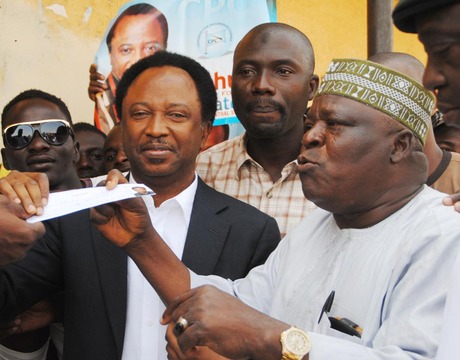 PRESIDENT, CIVIL RIGHTS CONGRESS OF NIGERIA, COMRADE SHEHU SANI (L), RECEIVING HIS APC MEMBERSHIP REGISTRATION CARD FROM THE PARTY CHAIRMAN FOR KADUNA SOUTH, ALHAJI BASHIR AHMED, DURING THE REGISTRATION EXERCISE IN KADUNA ON TUESDAY (11/2/14).