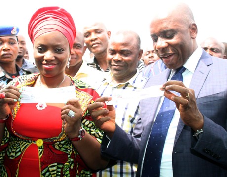 WIFE OF THE GOVERNOR OF RIVERS, MRS JUDITH AMAECHI (L) AND GOV. CHIBUIKE AMAECHI, DISPLAYING THEIR REGISTRATION SLIPS AS MEMBERS OF THE ALL PROGRESSIVES CONGRESS (APC) AT UBIMA IN RIVERS ON MONDAY (10/2/14).