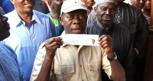 EDO STATE GOVERNOR ADAMS OSHIOMHOLE DISPLAYING HIS ALL PROGRESSIVES CONGRESS (APC) MEMBERSHIP CARD AFTER REGISTERING AT IYAMHO, ETSAKO WEST LOCAL GOVERNMENT AREA.. YESTERDAY