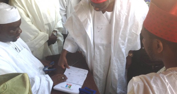 GOV. RABI'U MUSA KWANKWASO OF KANO STATE (CENTRE) BEING REGISTERED AS APC MEMBER BY THE KANO STATE CHAIRMAN OF THE APC REGISTRATION COMMITTEE, DR. MUSTAPHA INUWA, IN HIS WARD AT KWANKWASO TOWN ON THURSDAY