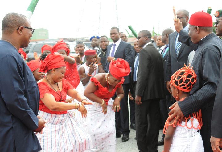 PRESIDENT GOODLUCK JONATHAN (R), ACKNOWLEDGING TRADITIONAL DANCERS HERALDING HIS ARRIVAL FOR THE GROUND BREAKING CEREMONY FOR  SECOND NIGER BRIDGE IN ONITSHA ON MONDAY (10/3/14). LEFT IS GOV. PETER OBI OF ANAMBRA.
