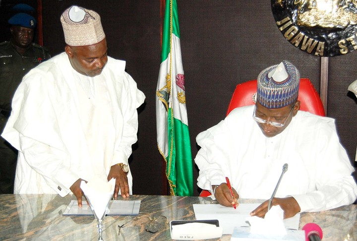 GOV. SULE LAMIDO OF JIGAWA SIGNING INTO LAW THE 2014 BUDGET IN DUTSE ON WEDNESDAY (26/3/14). WITH HIM IS THE COMMISIONER FOR FINANCE, ALHAJI UMAR RONI. 