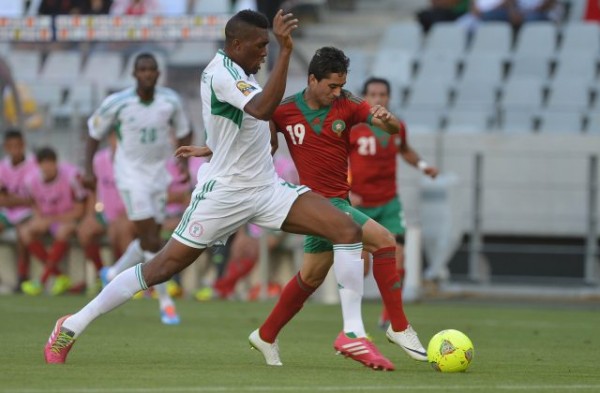 Azubuike Egwuekwe Tussles for the Ball With A Moroccan Player In a CHAN 2014 Match.