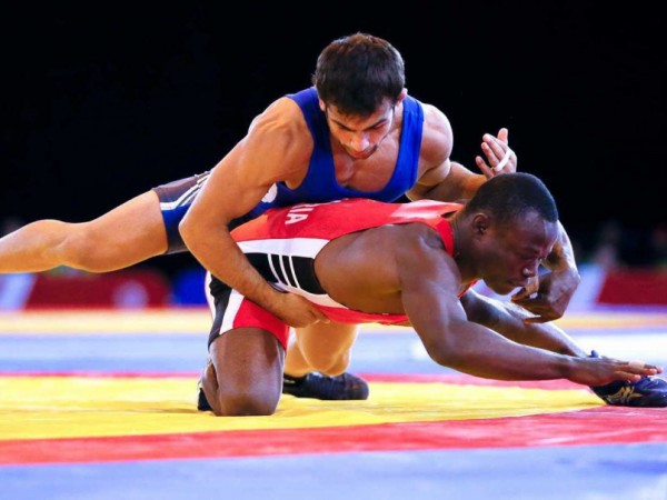Ebikweminomo Welson (red) Lost to India's Amit Kumar (Blue) in Men's 57kg Freestyle Wrestling on Tuesday. Image: AP.