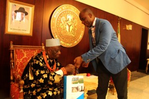 GOV. ROTIMI AMAECHI PRESENTING A SOUVENIR TO PRESIDENT OF THE SUPREME COUNCIL OF OGONI TRADITIONAL RULERS, KING GODWIN GININWA