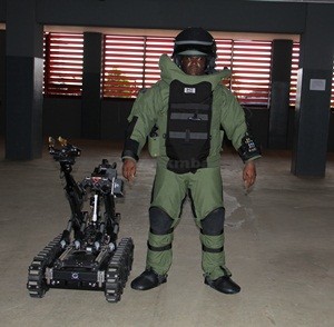 A-KITTED-POLICE-OFFICER-STANDING-BESIDE-ONE-OF-THE-BOMB-DISPOSAL-ROBOTS-PRESENTED-TO-THE-NIGERIA-POLICE-FORCE-BY-THE-US-EMBASSY
