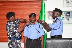 CP AMINCHI SAMAILA BARAYA BEING DECORATED WITH HIS NEW RANK BY THE IGP 