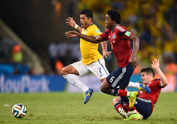 Carlos Sanchez Vies for the Ball With Brazil's Hulk During their Quarter-Final Clash at the World Cup. 