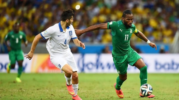 Didier Drogba Fends  Off the Challenges of Greece Defender Konstantinos Manolas During Ivory Coast's Final Group Game at the 2014 World Cup. Getty Image. 