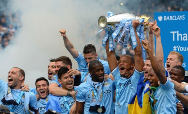 Captain Vincent Kompany Hoists the Premier League trophy After Man City Triumph in the 2013/14 Season.