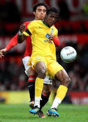Wilfried Zaha Challenged By Rafael Da Silva During a League Cup Game in 2012.