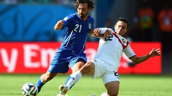 Andrea Pirlo Holds Off Costa Rica's  Jose Cuberos Tackle During a 2014 World Cup Group Game. Image: Getty.