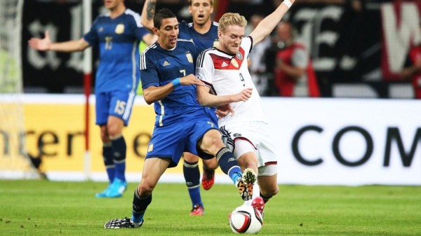 Angel Di Maria Tackle Andre Schurrle in Wenesday's International Friendly Against Germany. Image: AFP. 