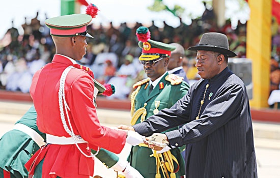 PRESIDENT JONATHAN (RIGHT), PRESENTING THE GOLDEN SWORD TO THE BEST ALL ROUND STUDENT, CDT S. O. IBRAHIM, AT THE GOLDEN JUBILEE PASSING OUT PARADE