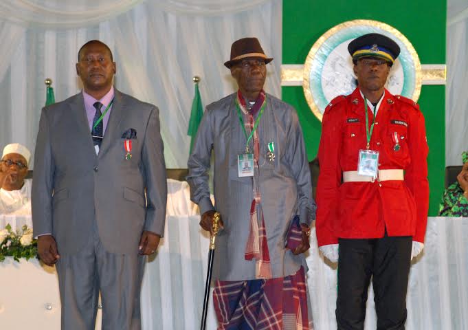 L-R; HEAD OF PRESIDENTIAL STEWARDS ONUH ISAAC MICHAEL (MON), TAXI DRIVER, MR. IMEH UBRU (MFR) AND TRAFFIC WARDEN, CPL.SOLOMON DAUDA (MON), AT THE 2013 AND 2014 NATIONAL HONOURS AWARD ON MONDAY.