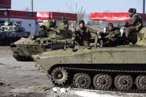 Fighters with the separatist self-proclaimed Donetsk People's Republic army sit on top of mobile artillery units in the town of Debaltseve