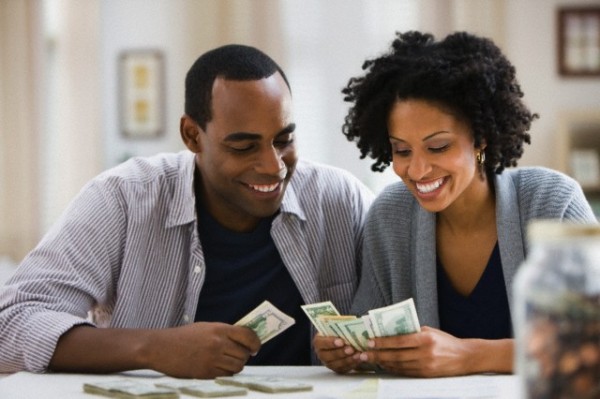 Couple counting money --- Image by © Jose Luis Pelaez Inc/Blend Image/Blend Images/Corbis