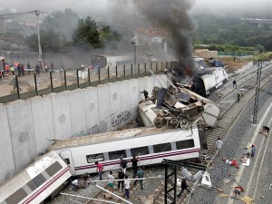 In this photo taken on Wednesday July 24 2013, Emergency personnel respond to the scene of a train derailment in Santiago de Compostela, Spain. Police say they have detained the driver of a train that crashed in northwestern Spain and killed 78 people. Galicia region National Police Chief Jaime Iglesias says driver Francisco Jose Garzon Amo was officially detained in the hospital where is recovering. (AP Photo/La Voz de Galicia/Monica Ferreiros)