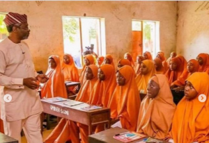 Femi Gbajabiamila teaching in a school