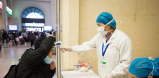 Passengers go through medical check aboard flight